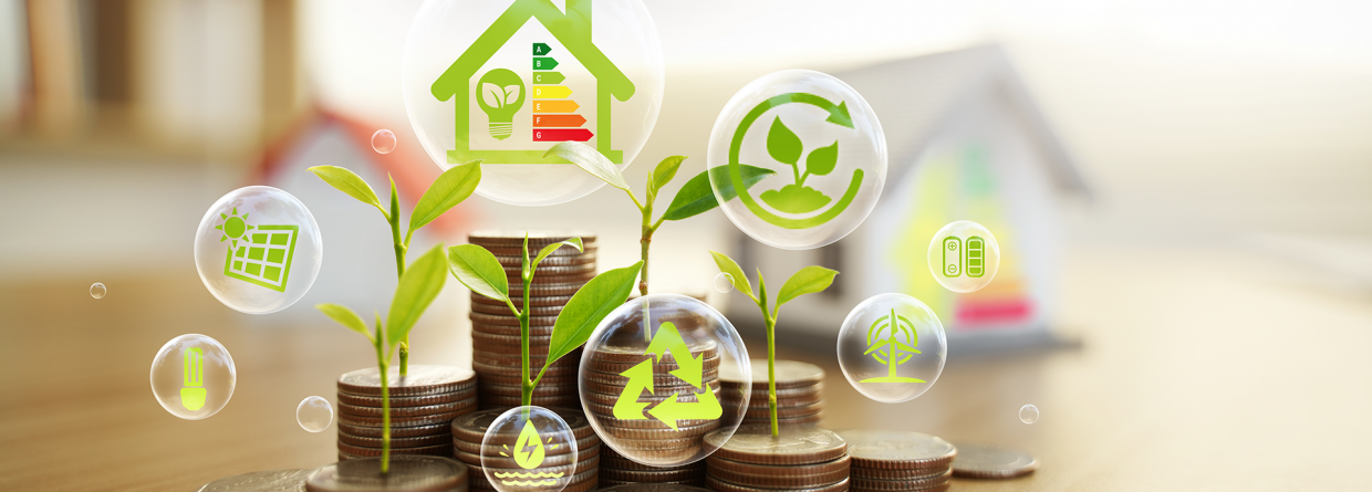 Stapels muntgeld met icoontjes erop van een plantje, windenergie, zonnepanelen